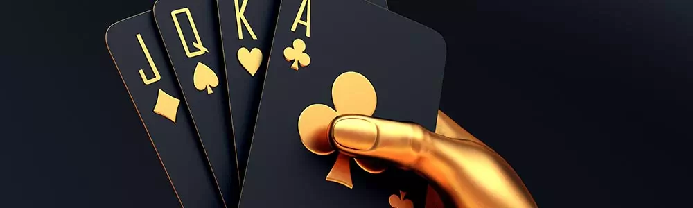 a gold hand holding classy black and gold cards hand of poker J, Q, K, A